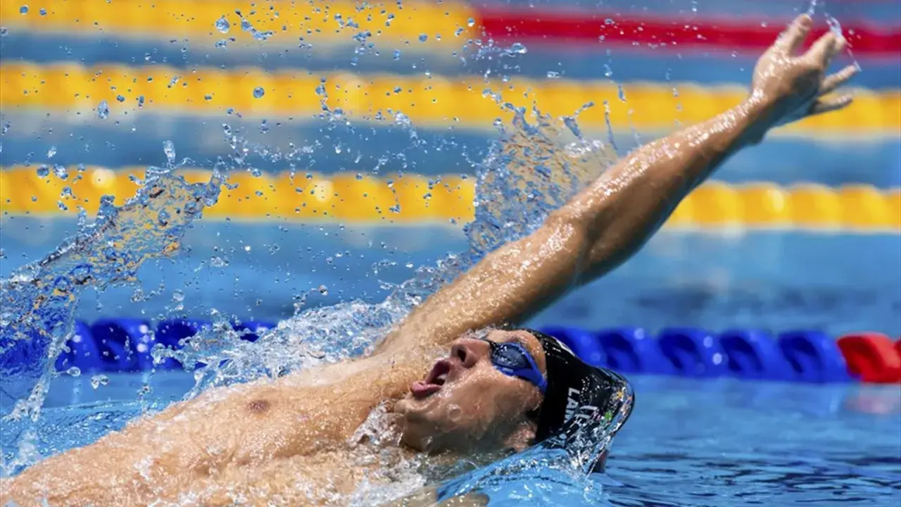 Michele Lamberti in azione, con il braccio teso e l'acqua che schizza, durante una gara di nuoto.