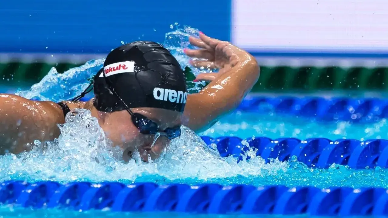 Stefania Pirozzi in azione, nuotando con determinazione. L'acqua schizza mentre si immerge per la prossima bracciata.