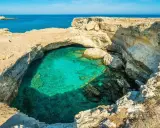 Splendide piscine naturali Sicilia, con acqua cristallina che invita al relax tra le rocce dorate.