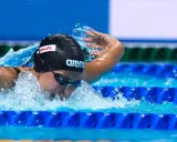 Stefania Pirozzi in azione, nuotando con determinazione. L'acqua schizza mentre si immerge per la prossima bracciata.