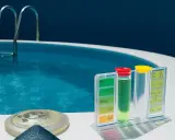 Kit per testare l'acqua della piscina. Il livello di cloro e pH è ideale, ma l'acqua della piscina appare torbida.