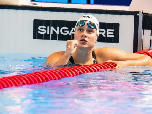 Anastasia Gorbenko, nuotatrice con cuffia e occhialini, esulta in piscina dopo una gara.